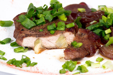 Grilled pork steak on white plate.