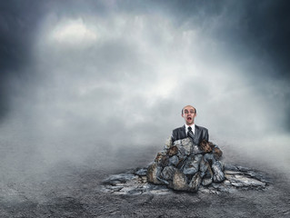 Scared businessman in the soil
