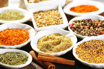 Different kinds of spices in ceramics spoons, close-up,