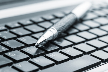 Pen on the keyboard - Powered by Adobe