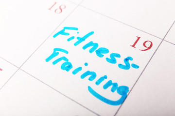 Written plan Fitness Training  on calendar page background