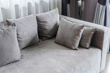 grey pillows on modern sofa in living room