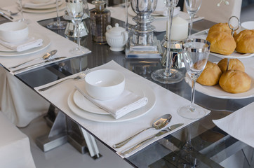 table set on glass table in dinning room