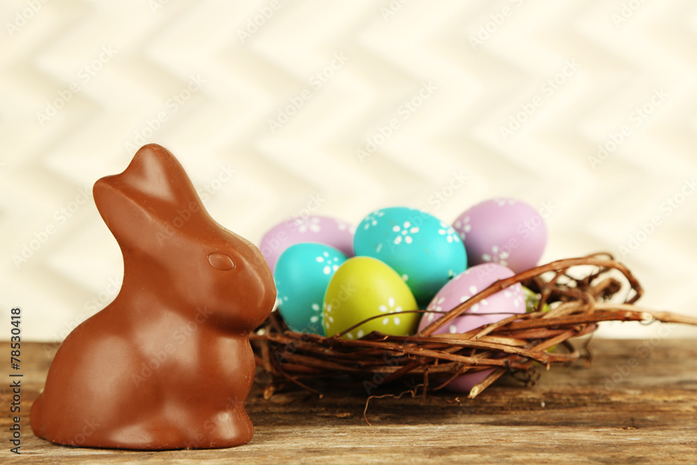 Wall mural easter composition with chocolate rabbit on light background