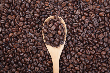 Roasted coffee beans with wooden spoon