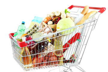 Shopping cart full with various groceries isolated on white
