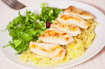chicken breast with pasta and salad
