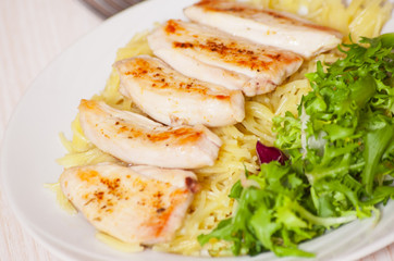 chicken breast with pasta and salad