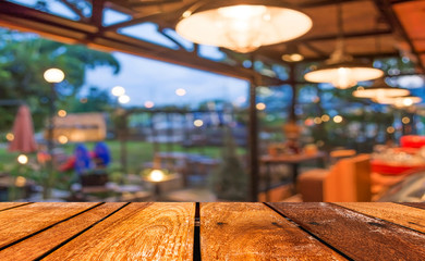 Empty wood table and Coffee shop blur background with bokeh imag
