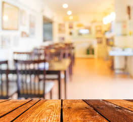 Empty wood table and Coffee shop blur background with bokeh imag