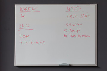 whiteboard with fitness instructions