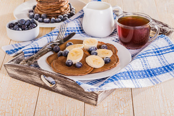Homemade chocolate pancakes with berries and banana