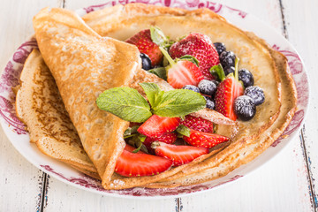 Homemade crepes with berries and fruit