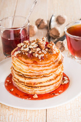 Homemade pancakes with walnuts and strawberry jam