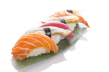 Sushi on a bamboo list over white background