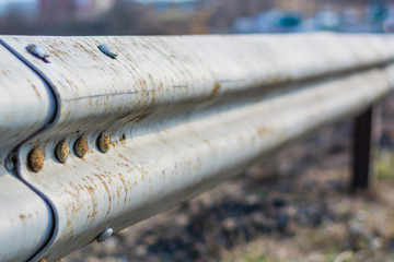 Metal highway fence near the old city road