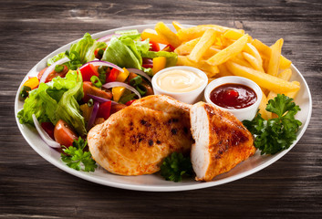 Fried chicken fillets, boiled potatoes and vegetable salad
