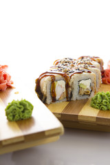 sushi on a wooden plate gete isolated on white background