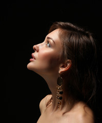Portrait of beautiful young woman face. Isolated on dark