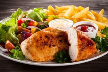 Fried chicken fillets, boiled potatoes and vegetable salad