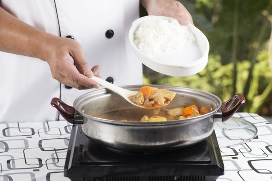 Chef shovel Japanese pork curry with steam rice