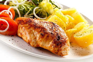 Fried chicken fillet, boiled potatoes and vegetable salad