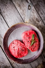 Two raw steaks in the pan