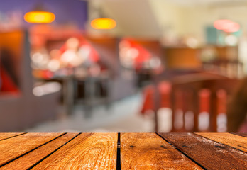 wooden table and  Coffee shop blur background with bokeh image