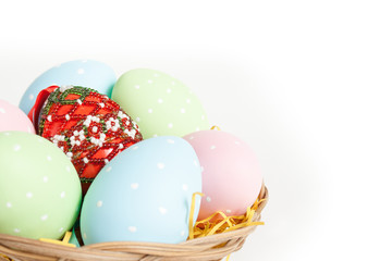 Easter basket with yellow grass filled with easter eggs