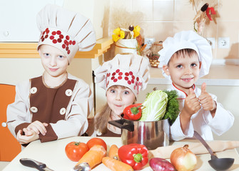 Beautiful kids together cooking. Interior photo