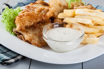 Fish and chips with tartar sauce on a plate