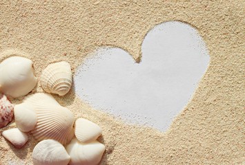 Heart on sea sand shells and paper background