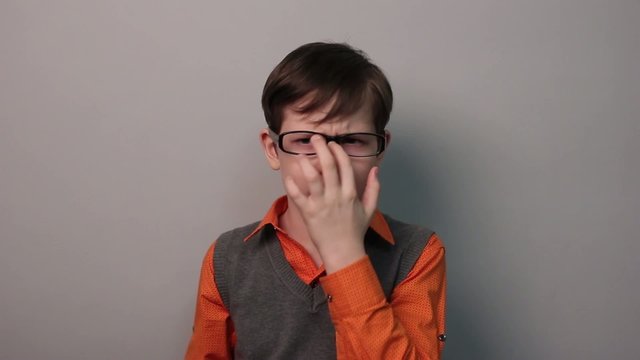 angry teenager boy wears glasses