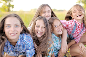 Fototapeta premium Portrait of joyful beautiful girlfriends on the nature