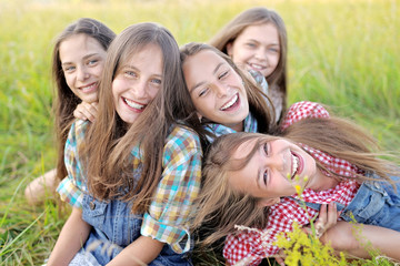 Portrait of joyful beautiful girlfriends on the nature