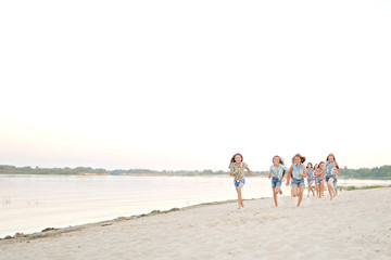 Portrait of joyful beautiful girlfriends on the nature