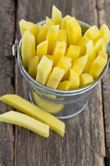 chopped potato in a bucket on wooden table