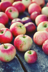 fresh red apples on wooden surface
