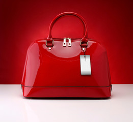 Red handbag on a red background - obrazy, fototapety, plakaty