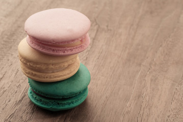 colourful stack flavoured macaroon on white wood background