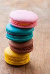 colourful stack flavoured macaroon on white wood background