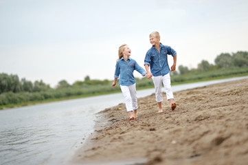 Portrait of a boy and girl on the beach in summer