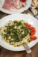 Spaghetti with spinach and bacon.