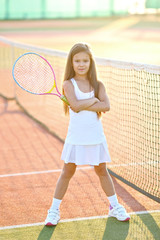 portrait of a little girl on the tennis court