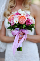Bride holding wedding bouquet of beautiful