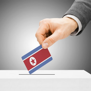 Voting concept - Male inserting flag into ballot box - North Kor