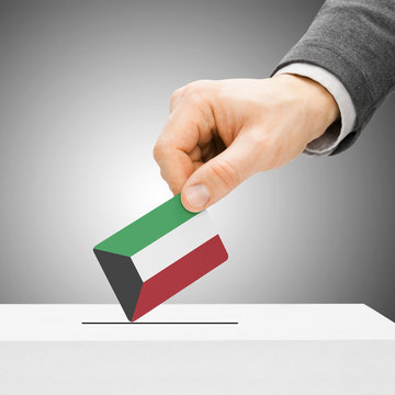 Voting concept - Male inserting flag into ballot box - Kuwait