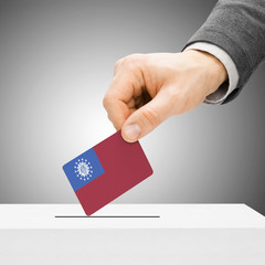 Voting concept - Male inserting flag into ballot box - Burma - M