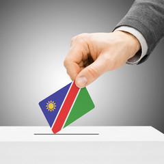 Voting concept - Male inserting flag into ballot box - Namibia