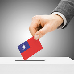 Voting concept - Male inserting flag into ballot box - Republic